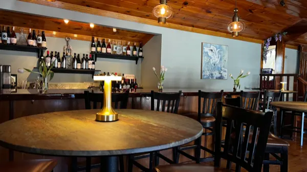 The bar and a lamp-lit round table inside the tea room