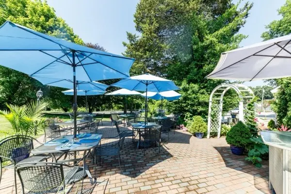 Blue umbrellas over the brick patio garden