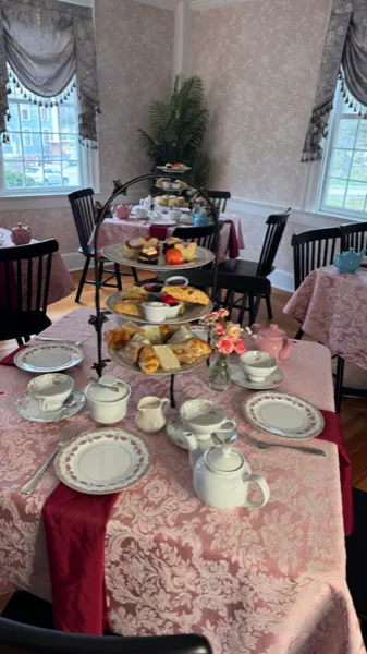 Tables set for afternoon tea beside a bright window