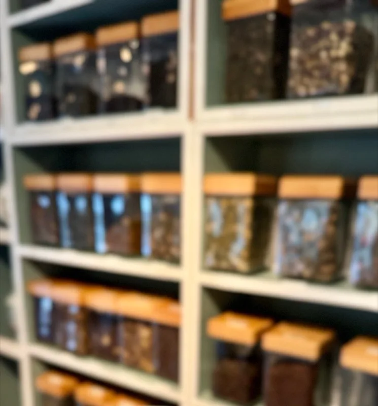 Shelves of glass jars filled with loose leaf tea