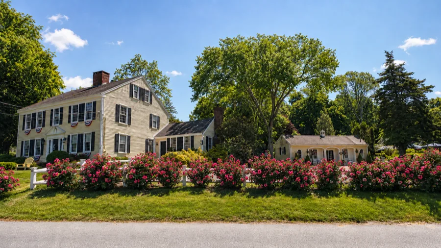 The Swan, a Colonial house set behind a bed of pink flowers